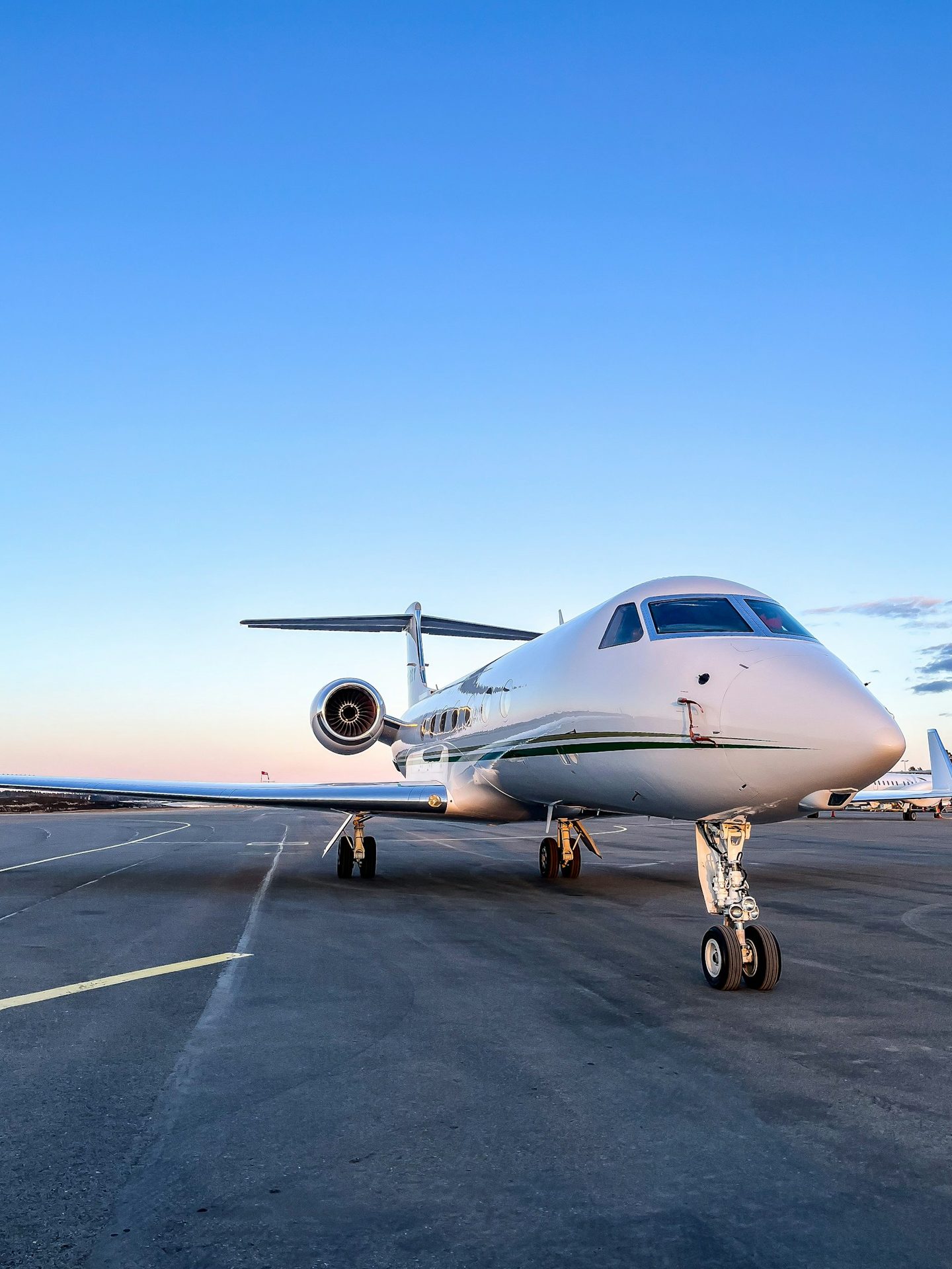 Private jet on ramp with luxury ground vehicle waiting